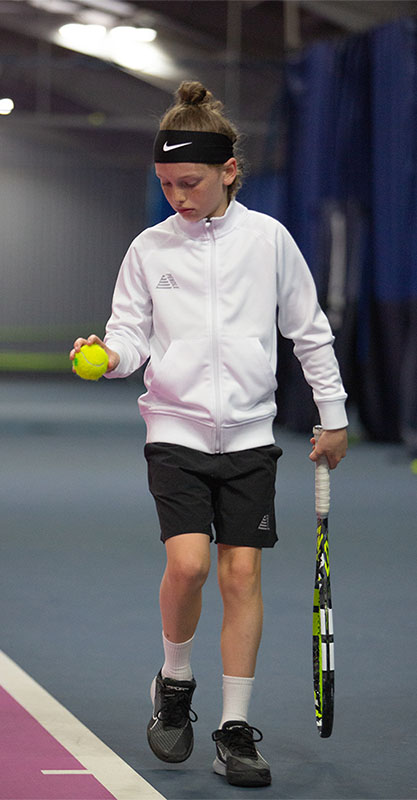 Kid Tennis Player Getting Ready to Serve